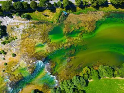 an aerial view of a golf course with water at Apartman Capital Novi Grad in Bosanski Novi