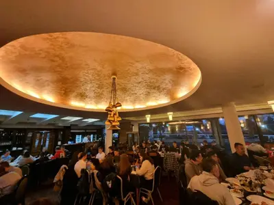a crowd of people sitting at tables in a restaurant at Hotel Paviljon in Bihać