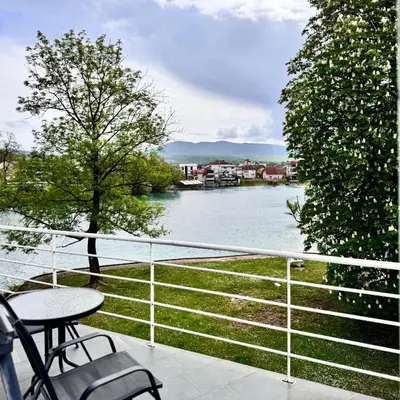 a balcony with a view of a river at Hotel Paviljon in Bihać