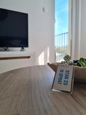 a sign sitting on a table in a living room at Apartman D&D in Banja Luka