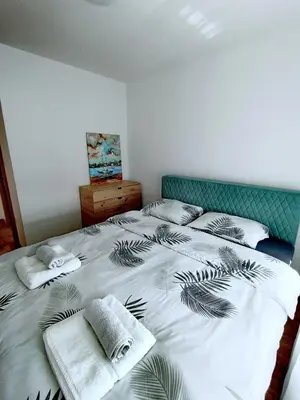 a bedroom with a large bed with towels on it at Apartman D&D in Banja Luka