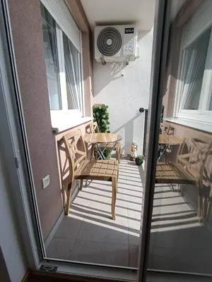 a balcony with two chairs and a table at Apartman D&D in Banja Luka