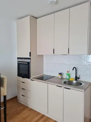 a kitchen with white cabinets and a sink at Apartman D&D in Banja Luka