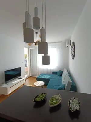 a living room with a bed and a table at Apartman D&D in Banja Luka