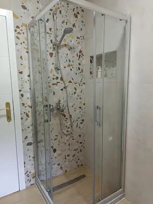 a shower with a glass door in a bathroom at Zen Apartment Tuzla in Tuzla