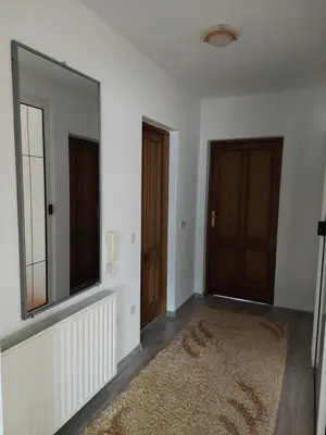 an empty room with two doors and a mirror at Apartmani Marin in Kupres