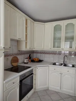 a white kitchen with white cabinets and a sink at Apartmani Marin in Kupres