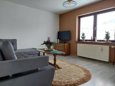 a living room with a couch and a tv at Apartmani Marin in Kupres