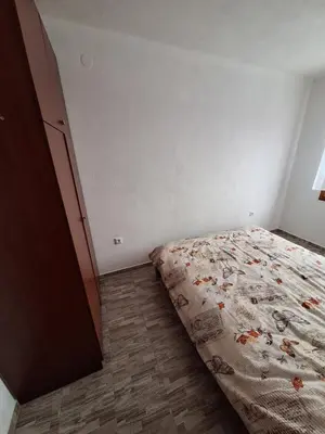 a bedroom with a bed and a wooden floor at Apartmani 