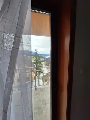 a sliding glass door with a view of a balcony at Apartmani 