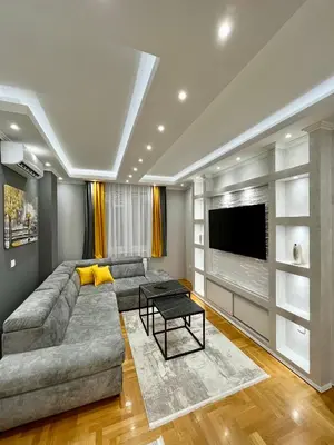 a living room with a couch and a tv at Apartman Central in Banja Luka