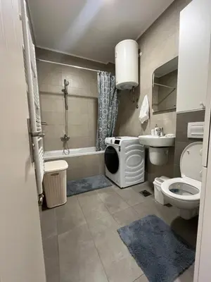 a bathroom with a toilet and a tub and a sink at Apartman Central in Banja Luka