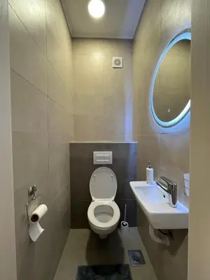 a bathroom with a toilet and a sink at Apartman Central in Banja Luka