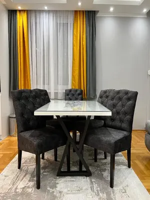 a dining room with a table and two chairs at Apartman Central in Banja Luka