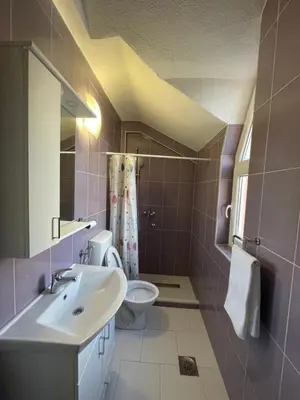 a bathroom with a sink and a toilet at Apartman Dolly Bell in Kotor-Varoš
