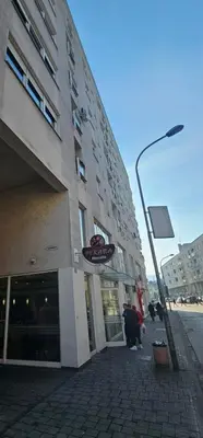 a building with a sign on the side of it at MARICELO in Banja Luka