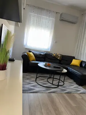 a living room with a black couch and a table at MARICELO in Banja Luka