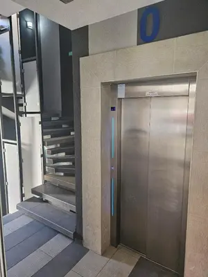 a metal elevator in a building with a staircase at MARICELO in Banja Luka