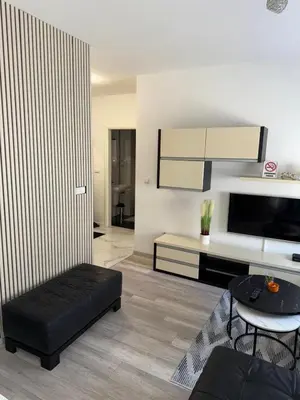 a living room with a black ottoman in a room at MARICELO in Banja Luka