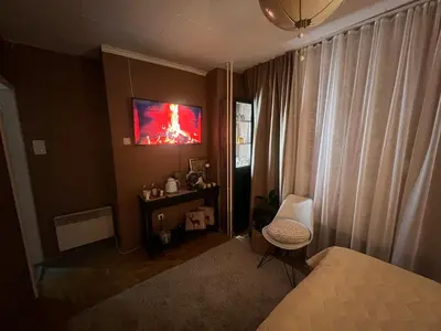 a bedroom with a bed and a tv on the wall at Banja Luka CITY2 in Banja Luka