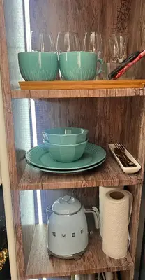 a shelf with three bowls and a slow cooker on it at Banja Luka CITY2 in Banja Luka