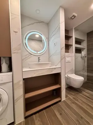 a bathroom with a sink and a toilet and a mirror at Urban Maisonette in Banja Luka