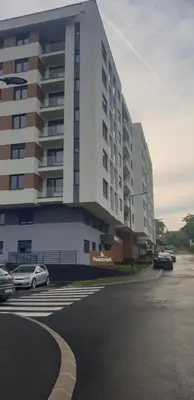 a large white building with cars parked in a parking lot at R-RESIDENCY Panorama in Banja Luka