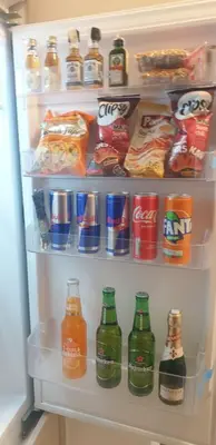 an open refrigerator filled with lots of drinks and snacks at R-RESIDENCY Panorama in Banja Luka