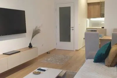 a living room with a couch and a flat screen tv at R-RESIDENCY Panorama in Banja Luka