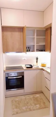 a kitchen with white cabinets and a stove top oven at R-RESIDENCY Panorama in Banja Luka