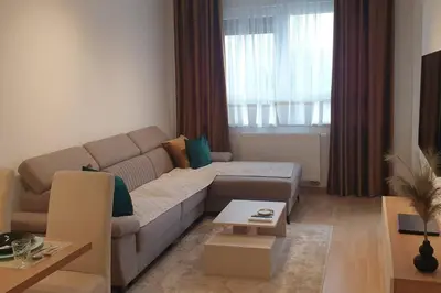 a living room with a couch and a table at R-RESIDENCY Panorama in Banja Luka