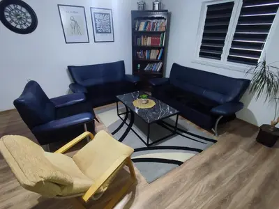 a living room with chairs and a couch and a table at Apartman Čolić - Kupres in Kupres