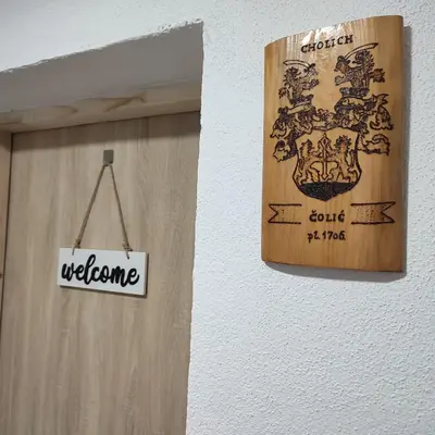 a welcome sign is hanging on a wall at Apartman Čolić - Kupres in Kupres