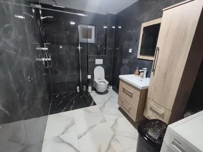 a bathroom with a shower and a toilet and a sink at Apartman Čolić - Kupres in Kupres