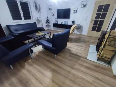 a living room with a couch and a table at Apartman Čolić - Kupres in Kupres