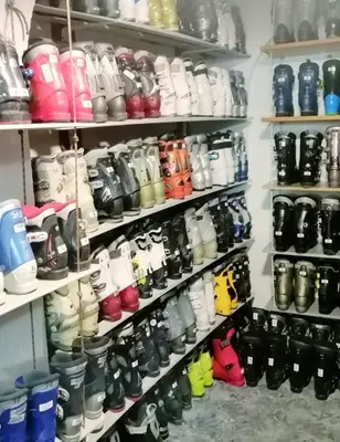 a shelf filled with lots of different colored shoes at Apartman Svalina in Kupres
