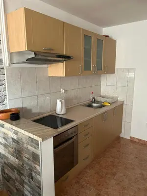 a kitchen with a sink and a counter top at Apartman Svalina in Kupres