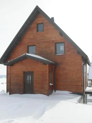 a log cabin with snow on the ground at Vila Ružica in Kupres