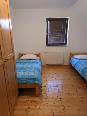 a small room with two beds and a window at Vila Ružica in Kupres