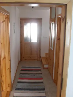 a hallway with a door and a rug at Vila Ružica in Kupres
