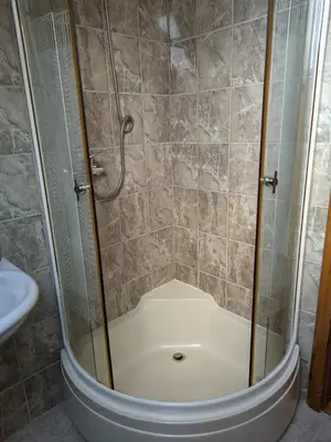 a shower with a glass door in a bathroom at Vila Ružica in Kupres