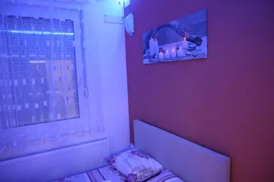 a bedroom with a bed and a window with a candle at Apartman Solunska 18 Banja Luka in Banja Luka