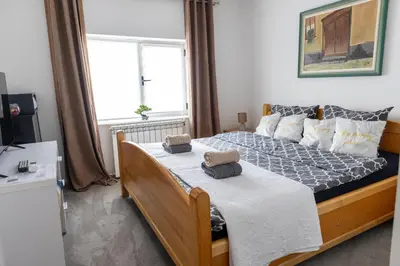 a bedroom with a bed with two towels on it at Guest House Lejla in Travnik