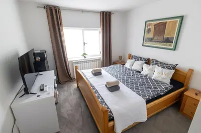 a bedroom with a bed and a television in it at Guest House Lejla in Travnik
