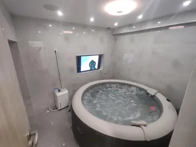 a large bath tub in a bathroom with a tv at Guest House Lejla in Travnik