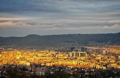 a view of a city at night with buildings at Apartmani Sebastijan in Banja Luka