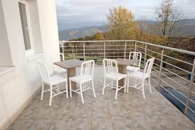a patio with a table and chairs on a balcony at Apartmani Sebastijan in Banja Luka