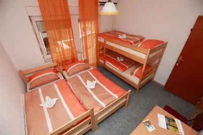 a small room with two bunk beds and a table at Hostel Cuba in Banja Luka