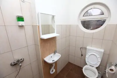 a small bathroom with a toilet and a sink at Hostel Cuba in Banja Luka