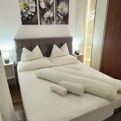 a large white bed with two pillows on it at Apartman Stojić in Banja Luka